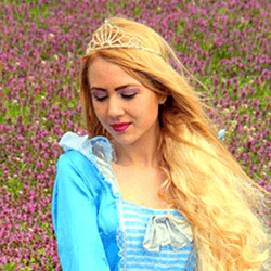 Princess in field light blue dress and crown